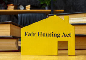 FHA fair housing act concept. Wooden model of house with an inscription.
